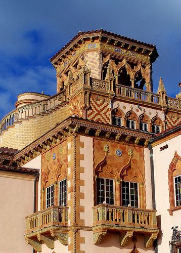 Decorative architectural details of a building with intricate designs and a blue sky.